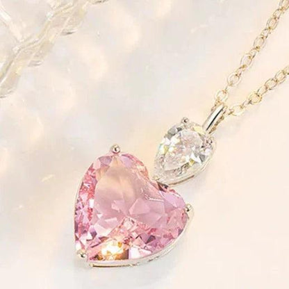 Heart pendant necklace featuring pink heart stone and clear heart stone on chain