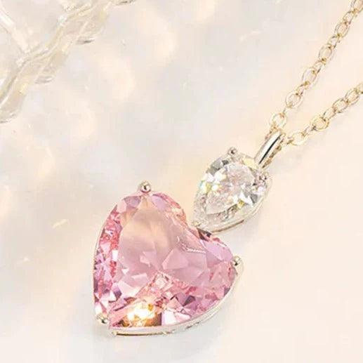 Heart pendant necklace featuring pink heart stone and clear heart stone on chain