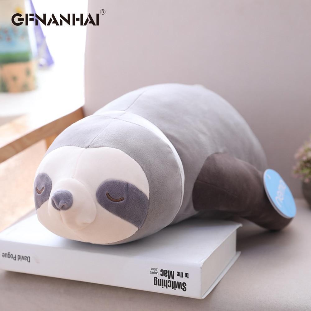Grey and white sleeping sloth plush with closed-eye face and curved tail
