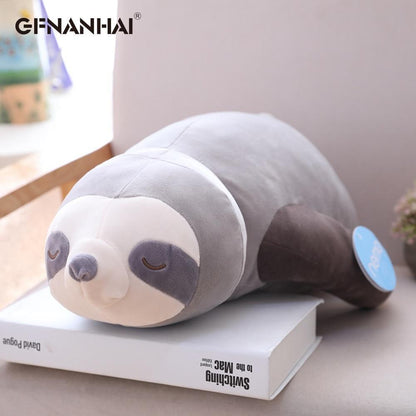 Grey and white sleeping sloth plush with closed-eye face and curved tail