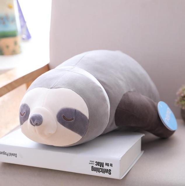 Grey and white sleeping sloth plush, lying on its side with small smile