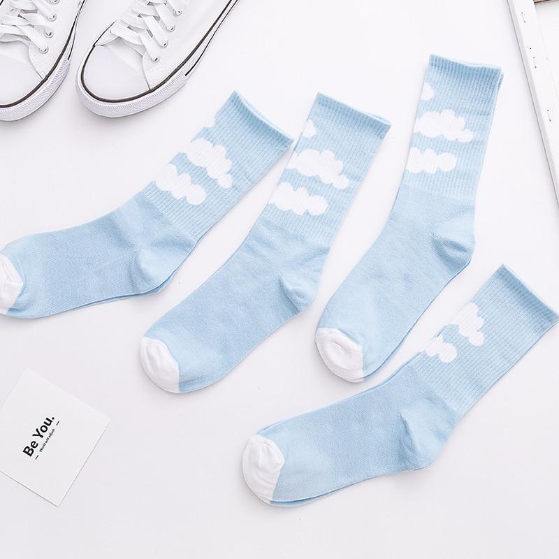 Light blue socks with white cloud pattern, ribbed cuff and round toe.