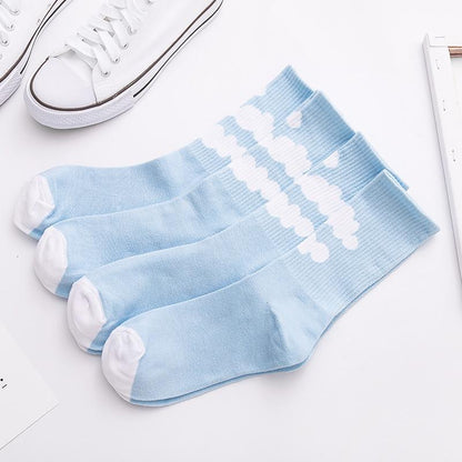 Light blue crew socks with white cloud pattern across the leg, ribbed knit.