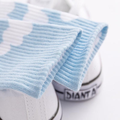 Light blue ribbed sock knit detail with small white cloud motif.