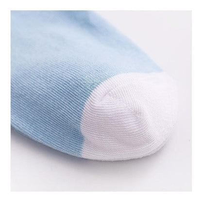 Light blue crew sock toe with white knit panel, ribbed fabric texture.