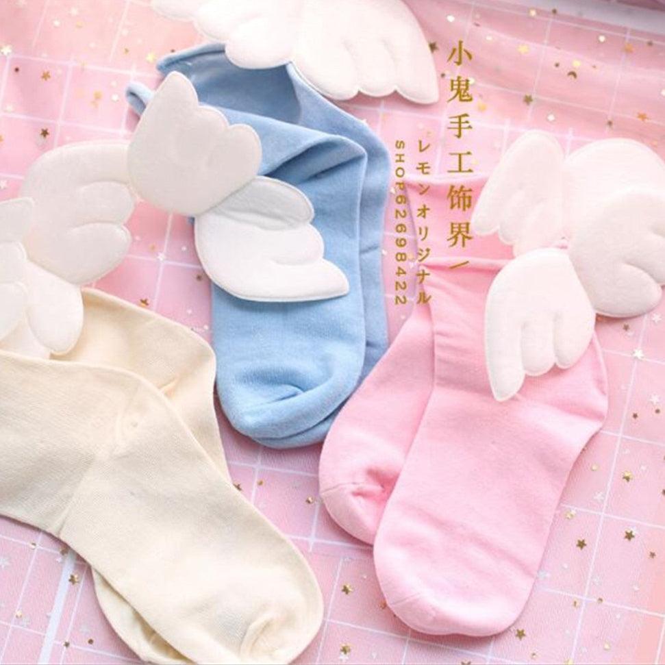 Angel wing socks with white cloud-like wings, blue knit crew style.