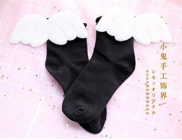 Angel wing socks with white cloud wings, black knit crew socks.
