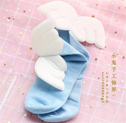 Angel wing socks with white cloud wings, light blue knit crew socks.