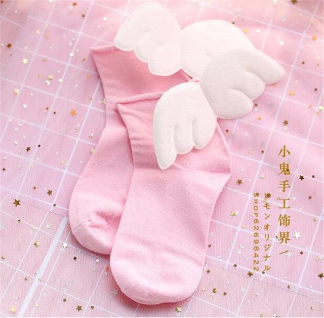 Angel wing socks with white cloud wings, pink knit crew socks.