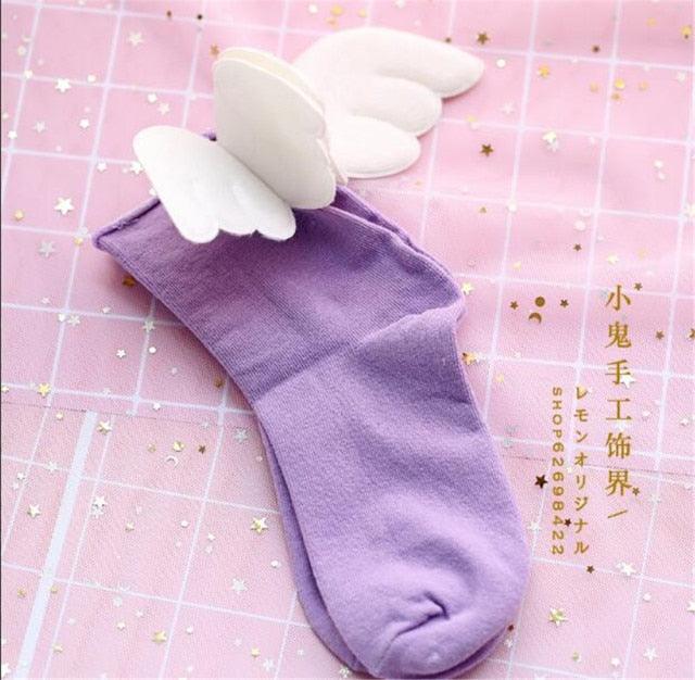 Angel wing socks with white cloud wings, purple knit crew socks.