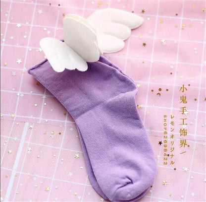 Angel wing socks with white cloud wings, purple knit crew socks.
