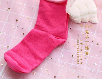 Angel wing socks with white cloud wings, bright pink knit crew socks.