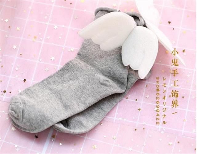 Angel wing socks with white cloud wings, grey knit crew socks.