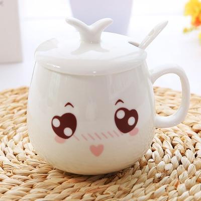 White ceramic face mug with lid, wide eyes, blush cheeks, and a small pink heart