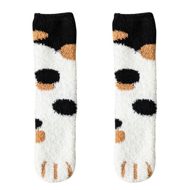 Pair of black-and-white socks with tan and brown cat paw motifs at the toe