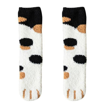 Pair of black-and-white socks with tan and brown cat paw motifs at the toe