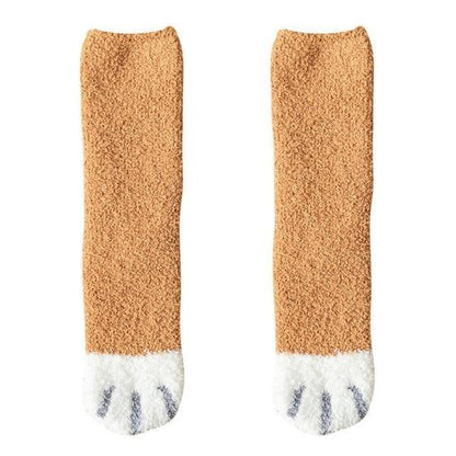 Tan knit socks with white toe panel and black cat-face pattern
