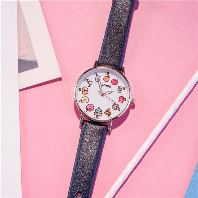 Blue strap wristwatch with round silver case and colorful food-themed dial