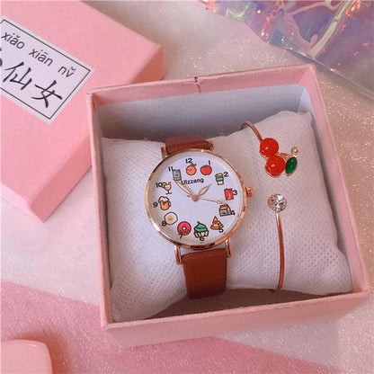Gift box set showing brown strap watch with food-themed dial and red cherry charm bracelet