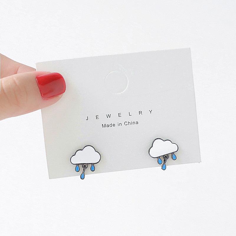 Cloud-shaped stud earrings with blue raindrop details and dark outlines