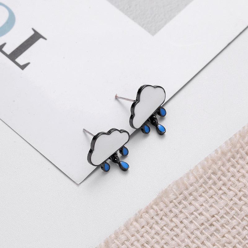 Cloud-and-rain stud earrings with white clouds, blue drops, and dark posts