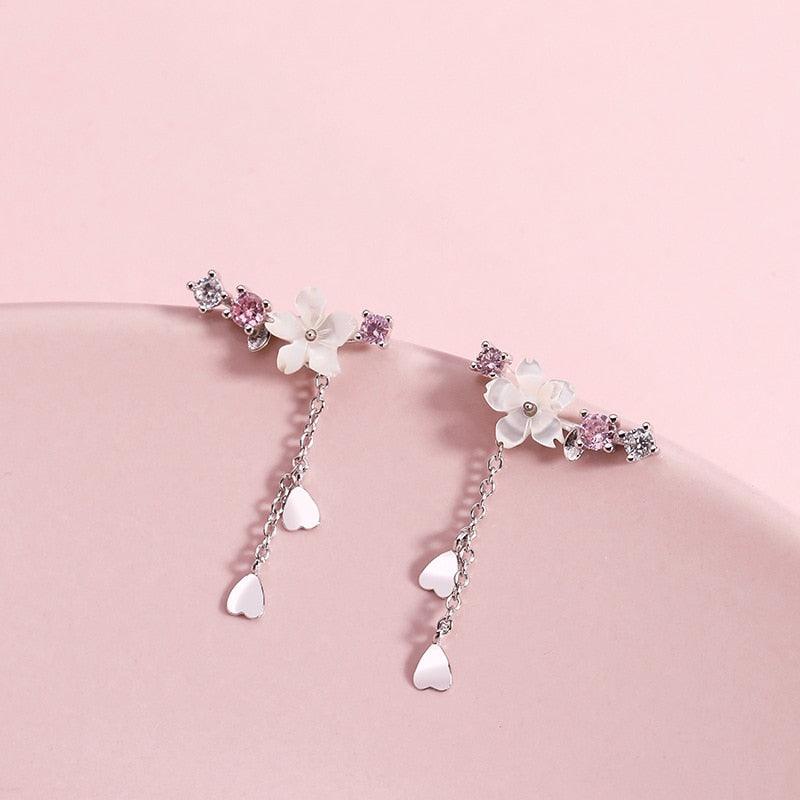 Cherry blossom drop earrings featuring pink crystal flowers with heart and teardrop charms