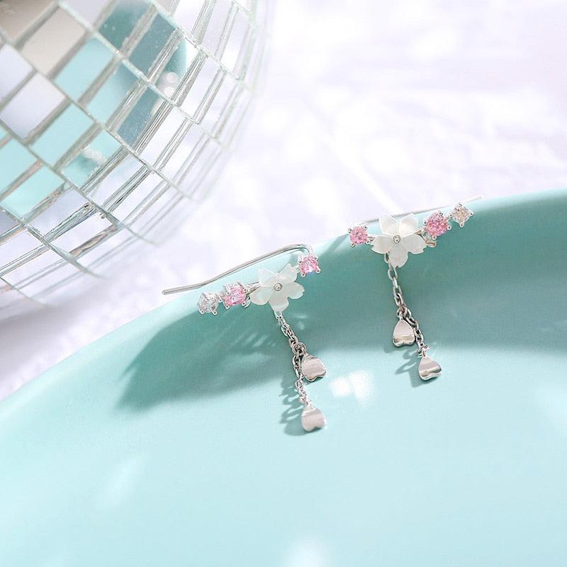 Cherry blossom drop earrings with pink crystal details and dangling heart charm strands