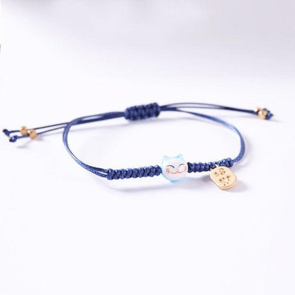 Blue cord cat charm bracelet with light blue cat bead and gold-tone heart tag