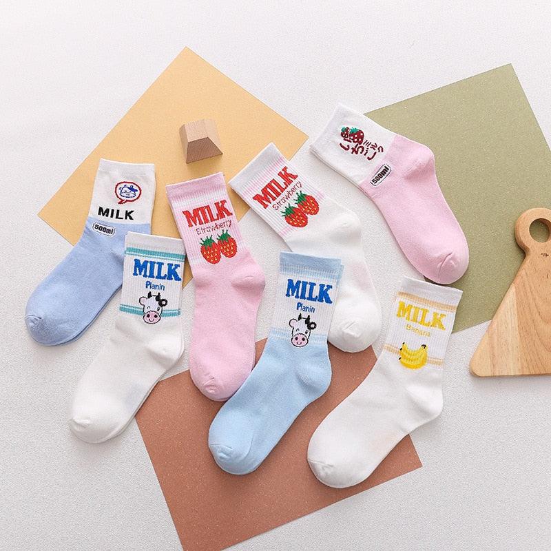 Kawaii milk-themed socks set with pink strawberry prints, plus white and blue options shown