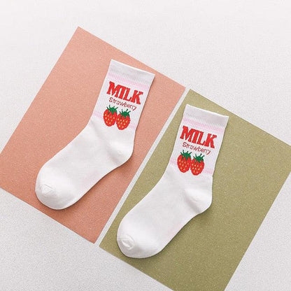 Pairs of white socks with red strawberry “MILK” text cuffs