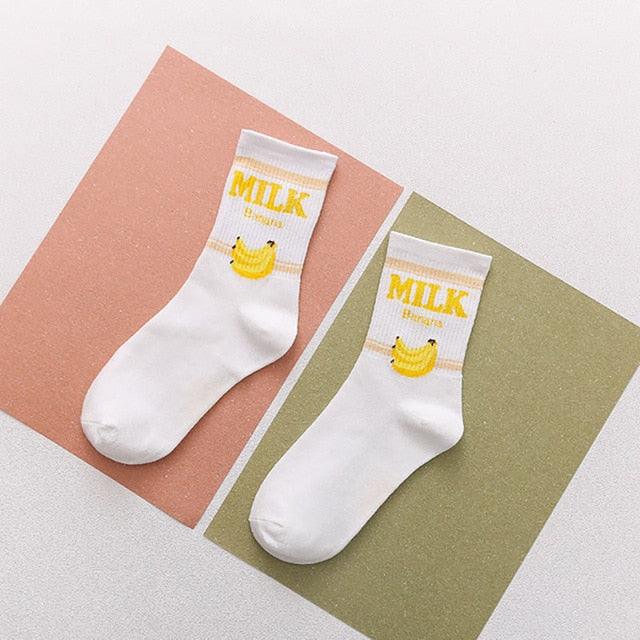 White socks with yellow banana “MILK” text and small banana graphic
