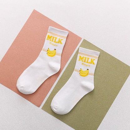 White socks with yellow banana “MILK” text and small banana graphic