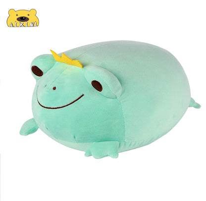 Green frog plush with yellow crown, smiling stitched face, and rounded body