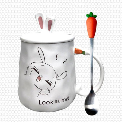 White ceramic bunny mug: 'Look at me!' rabbit face with pink ears, carrot-handled spoon.