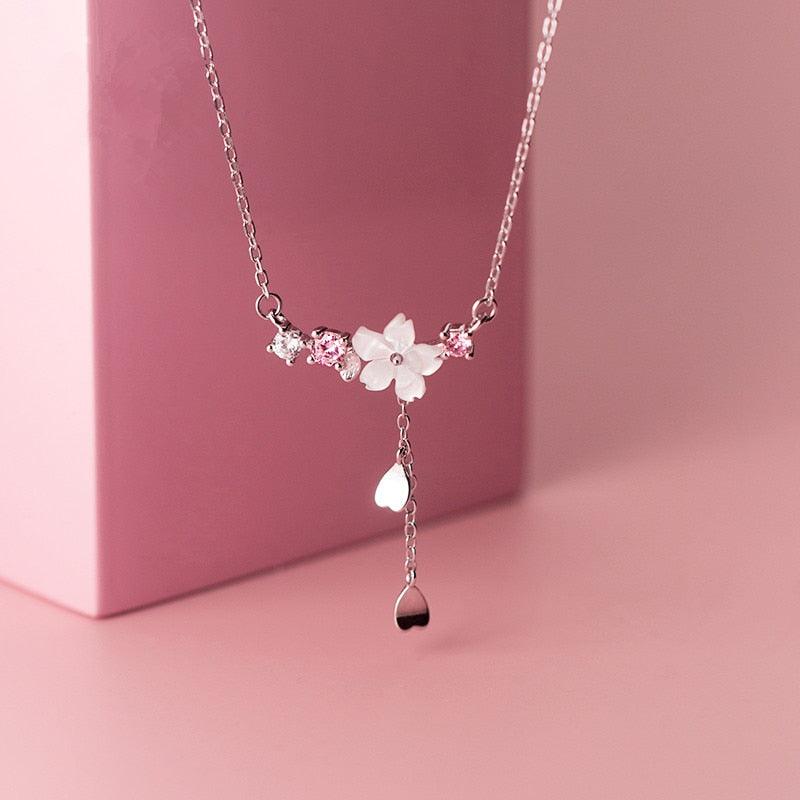 Silver-tone pendant necklace with sakura flower and dangling teardrop charm
