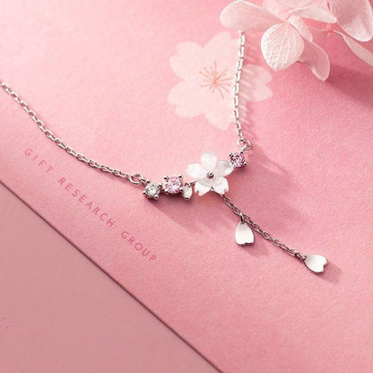 Silver-tone sakura pendant necklace with heart-shaped charms and flower cluster