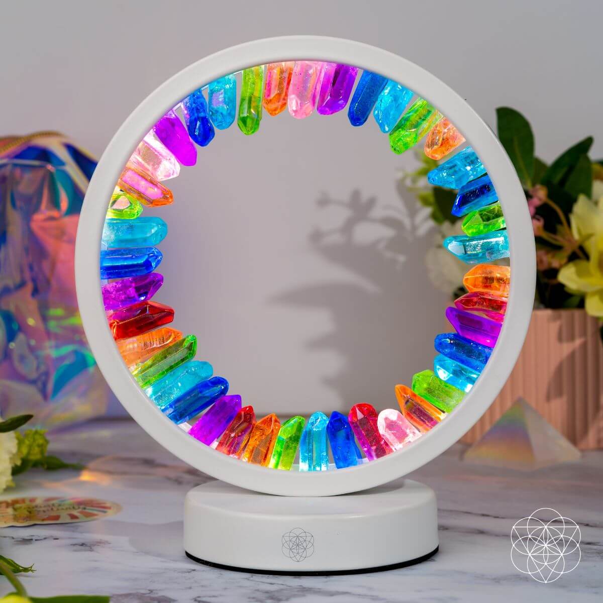Circular multicolor aura lamp with glowing rainbow ring on a white base