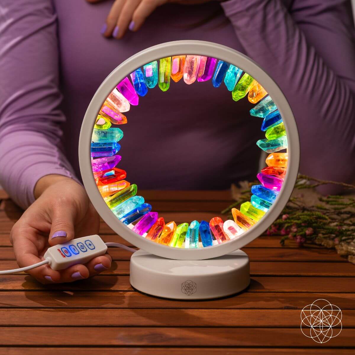 Multicolor rainbow aura lamp with remote control beside the glowing ring