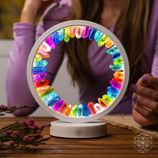 Circular multicolor aura lamp, shown with hands near the glowing ring and base