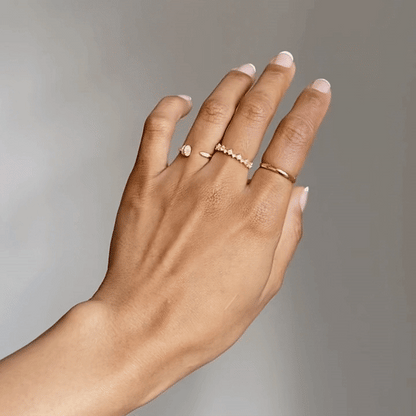 Gold-plated band ring on hand, smooth thin band profile
