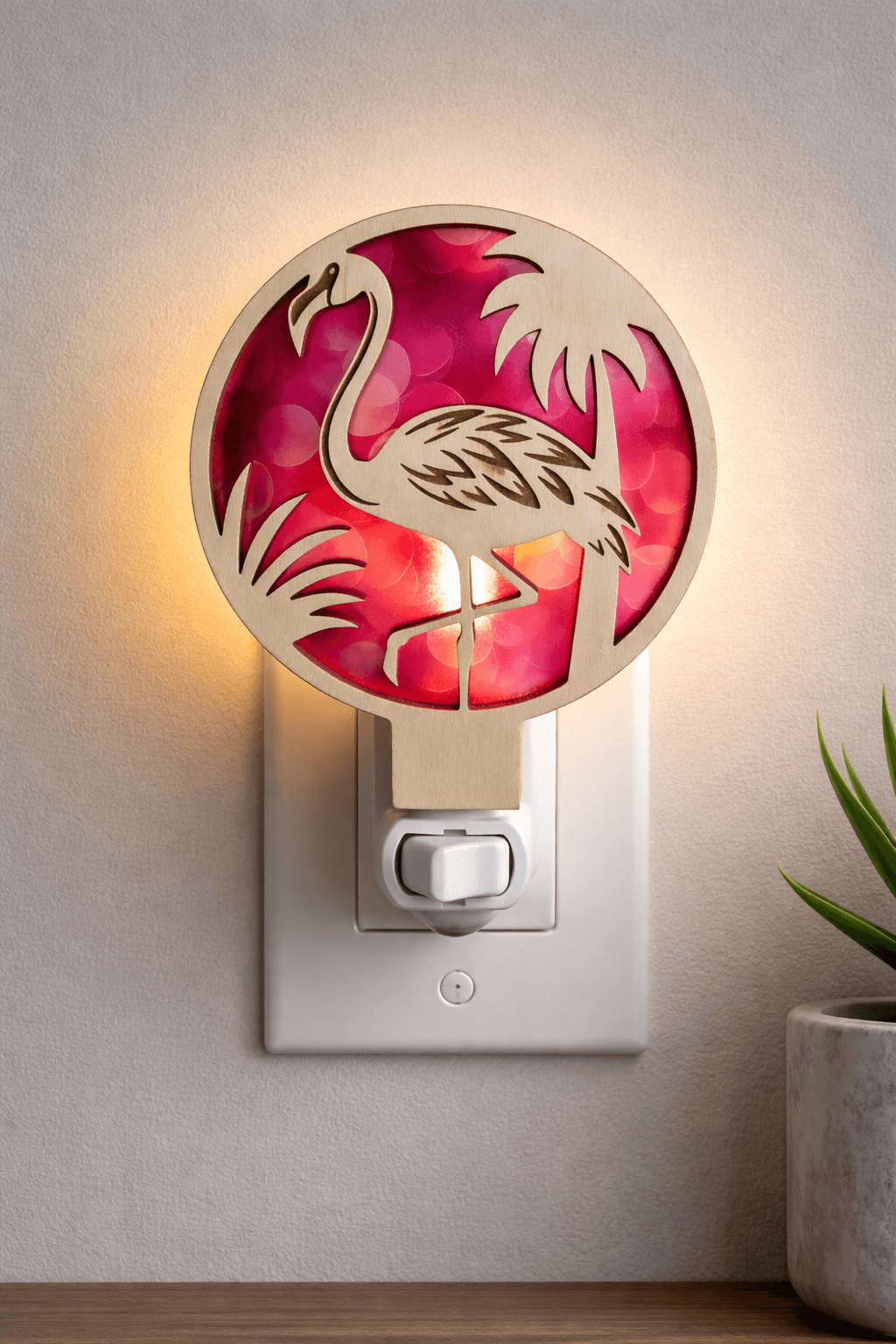Flamingo tropical LED nightlight with circular tropical design and pink light glow, wall plug