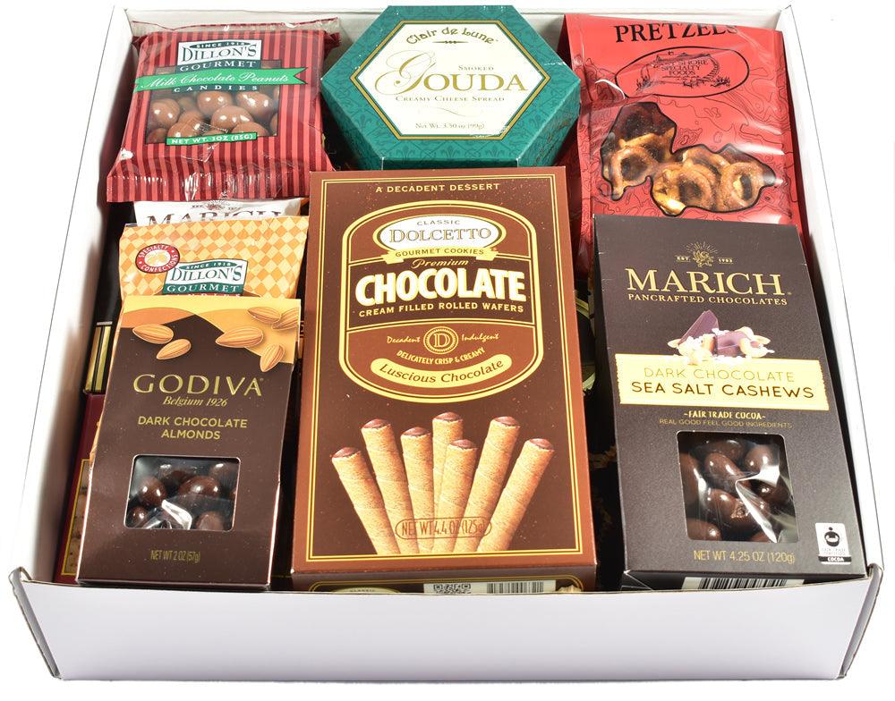 Open gift box filled with chocolate bars, pretzels, and cookies, arranged in rows