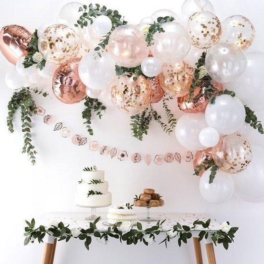 Rose gold and white balloon garland with metallic pearl balloons and eucalyptus greenery