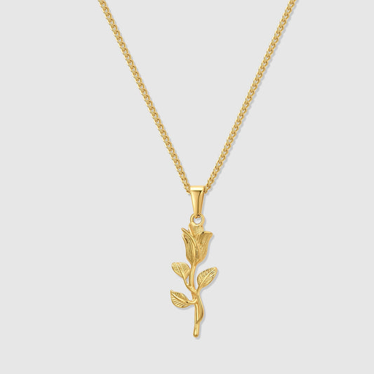 Gold rose pendant necklace with curb chain and leaf-branch drop pendant