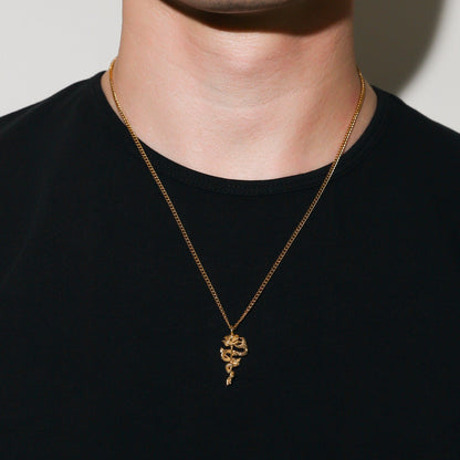 Gold serpent rose pendant necklace with coiled rose charm centered on the chest