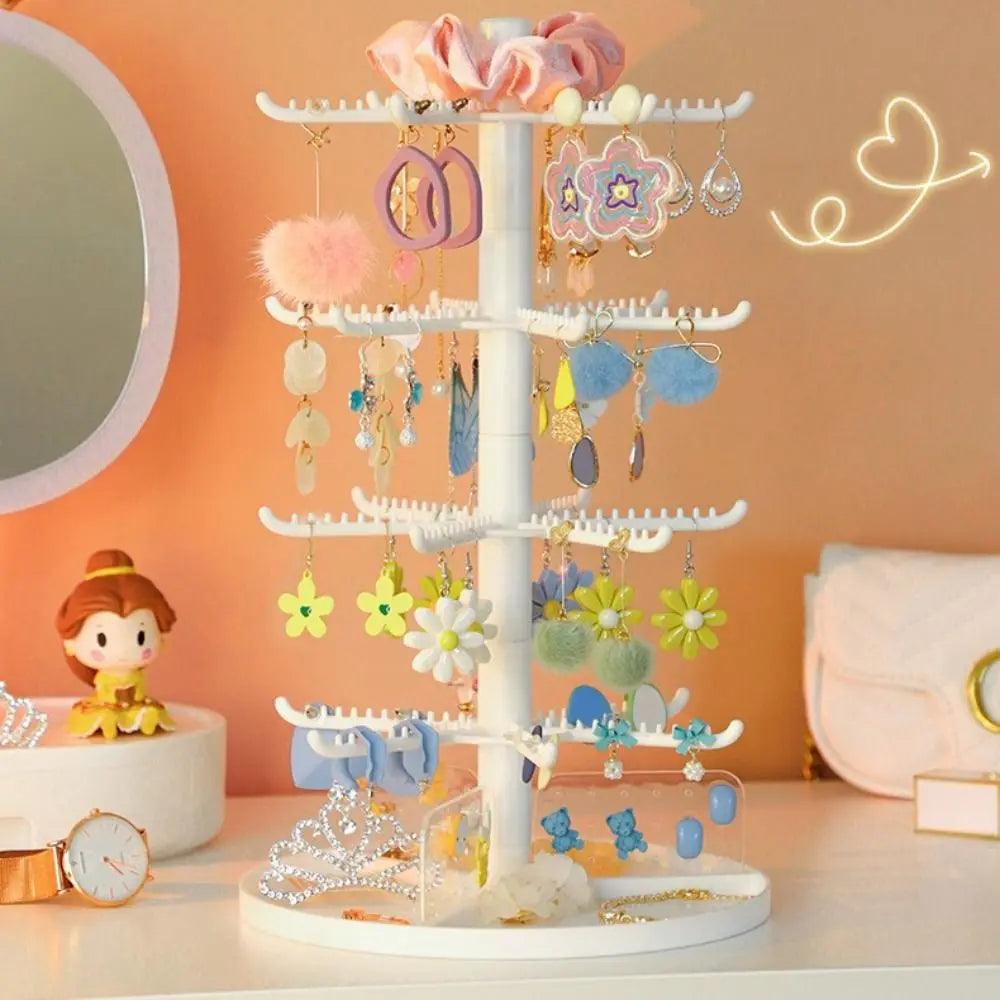 White rotating earring display stand with three tiers of horizontal hooks