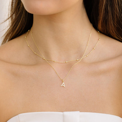Gold satellite chain necklace with small bead stations and letter A charm