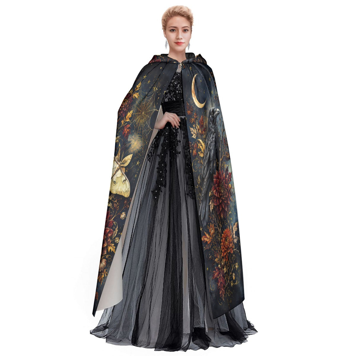 Model wearing hooded cloak cape with moth graphic and flowing floral pattern