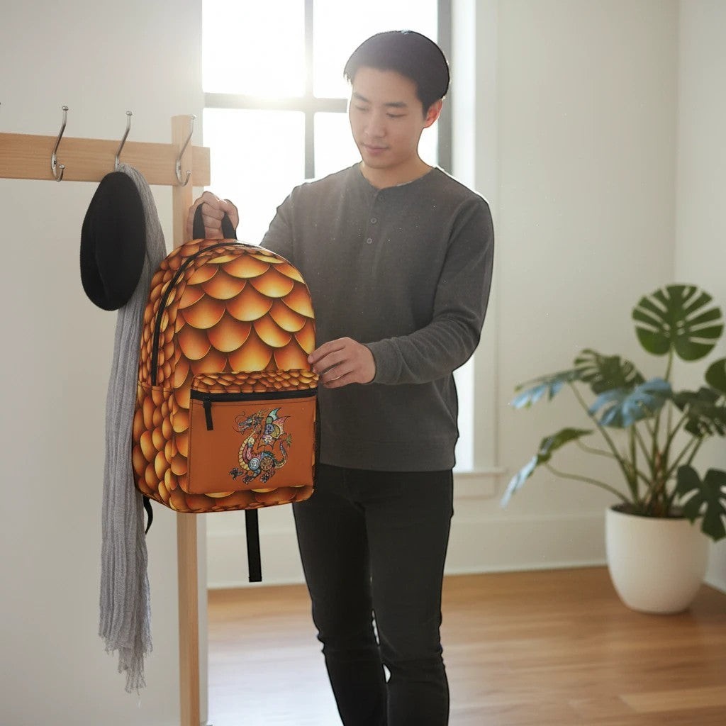 Dragon-scales backpack held up, showing front pocket and illustrated dragon