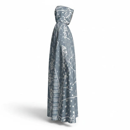 Hooded cloak cape in dark blue-gray with white snowflake pattern, angled view